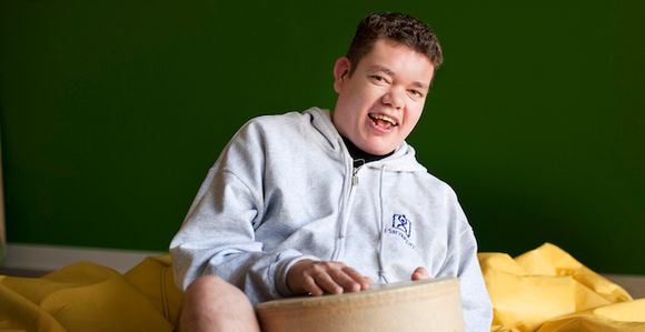 Man laughing with PCS sweatshirt